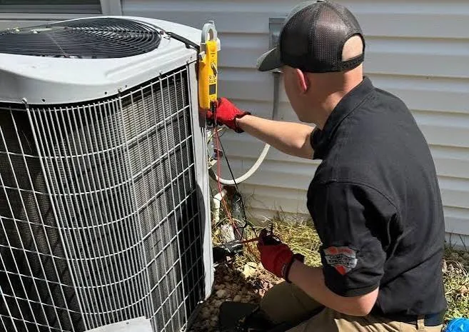 HVAC technician performing maintenance on an outdoor condenser